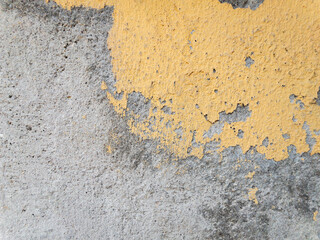 Closeup texture of yellow painted weathered concrete wall