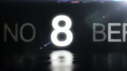 Glowing November 8 date text with cinematic lighting and reflection on a dark wet surface