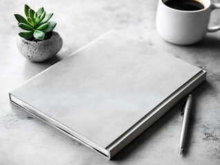 Minimalist workspace featuring a blank notebook with coffee and succulent