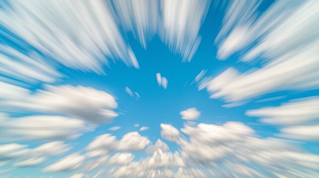 A dynamic zoom effect reveals fluffy white clouds against a vibrant blue sky creating an ethereal feel