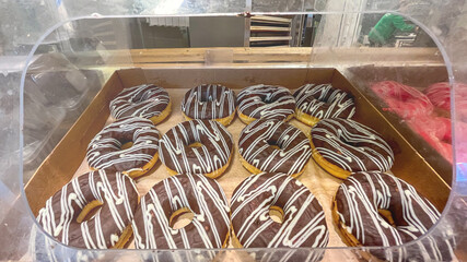 Donuts with chocolate glaze in supermarket.
