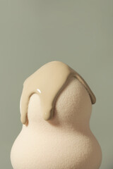 Cosmetic beauty product or blending tool. Egg shaped sponge and foundation smudge on it.