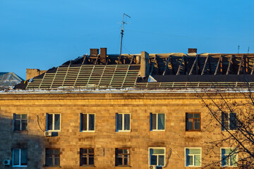 Replacing the covering on the pitched roof of an old large building. Repair works on sloping roof of house