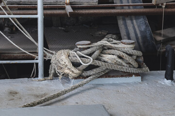 Mooring bollard. Moored ropes in summer