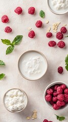 Vibrant red raspberries and creamy white yogurt create a fresh, elegant composition on a soft textured background, showcasing natural ingredients.