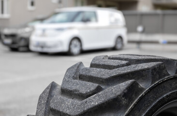 Close-up of Rugged Tire Tread with Delivery Van Background