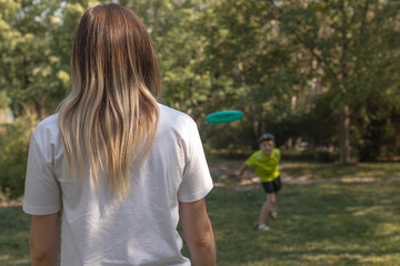 A family of two is playing with frisbee