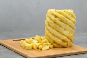 Peeled yellow pineapple in cross section, cut into pieces
