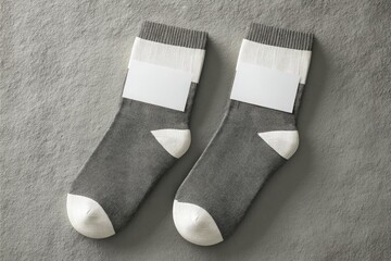Two gray socks with white trim and blank business cards
