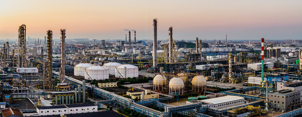 A large oil refinery and petrochemical plant with industrial equipment at dusk