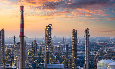 Oil refinery and petrochemical plant with industrial equipment against a beautiful and dramatic sunset sky
