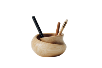 Wooden pen holder with pens and brushes.