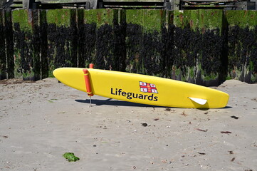 A lifeguards Paddleboard on Littlehampton Beach in the UK.