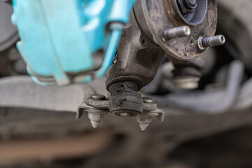Close up Front ball joint of car is damaged from use and deterioration, grease stains leaking out,...