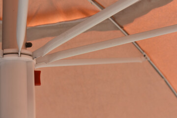 Parasol, summer and holidays. 
Summer beach in Italy and orange umbrella offering shade under the...
