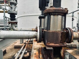 old steam locomotive. Rusty industrial pump and joints with rubber expansion coupling, showing...