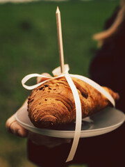 a woman in a black hat with a bag on the background of the field
