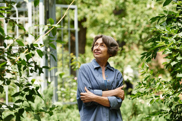 Joyful moments enjoyed by a senior woman in a vibrant garden filled with greenery and beauty
