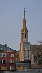  Spire of Saint Joseph church in neo gothic style in downtown Eupen, Belgium, in soft evening sunlight 