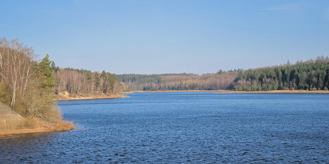 Deep blue lake of Eupen. Artificial lake for drinking water supply. with mixed forest around....