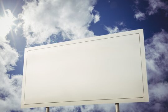 Fototapeta White billboard against cloudy sky