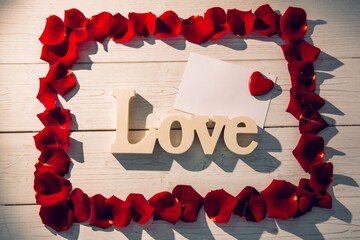 Frame of red rose petals with love text