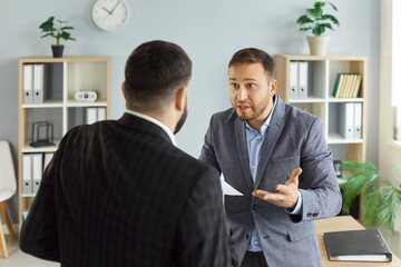 Angry business people colleagues disputing having disagreement fighting at workplace. Aggressive dissatisfied coworkers arguing having conflict standing in office. Business conflict concept.