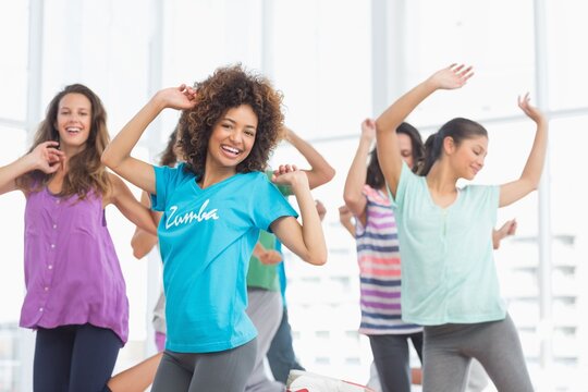 Flat design illustration is depicting five women dancing in sunlit studio, with Zumba logo