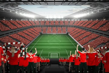 Vast football stadium with fans in red