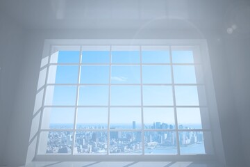 Room with large window showing city