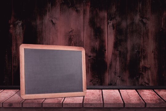 Fototapeta Black board on a wooden table