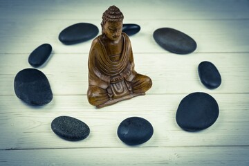 Buddha statue in circle made from pebbles
