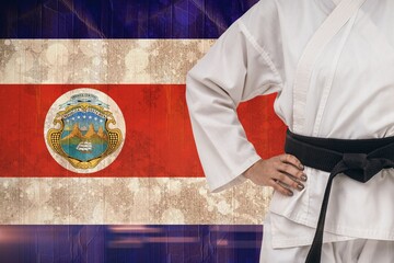 Midsection of martial artist standing against Costa Rican flag