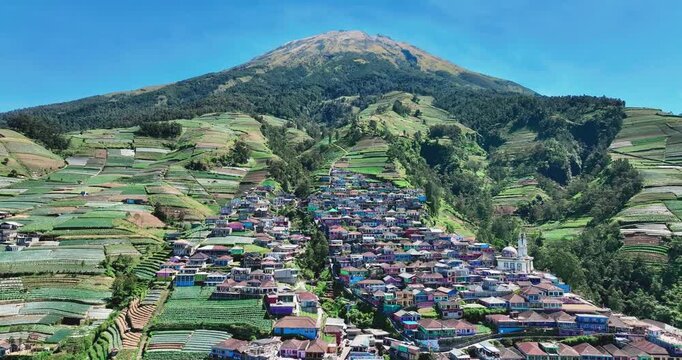 A village known as the &ldquo;Nepal of Java&rdquo; flows down the terraced slopes of the majestic Mount Sumbing under a clear blue sky.