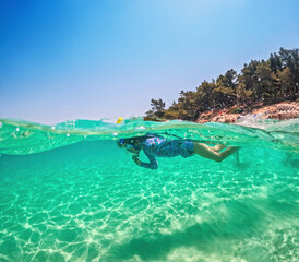 Child Snorkeling Underwater in Crystal Clear Tropical Sea Ocean Water Greece summer vacation