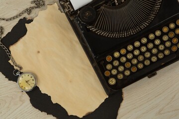 Paper piece, typewriter and clock on table