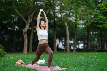 Female Doing Yoga Exercise in City Park