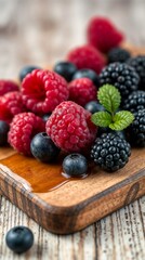 Fresh raspberries, blueberries, and blackberries placed on a rustic wooden cutting board.