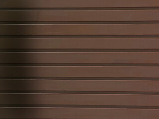 A textured brown background with horizontal lines. The surface appears smooth and uniform, suitable...