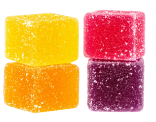 Colorful gelatin cubes arranged in two stacks, revealing translucent texture and sweet appeal on clear surface