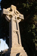 Low angle view of tombstone by tree