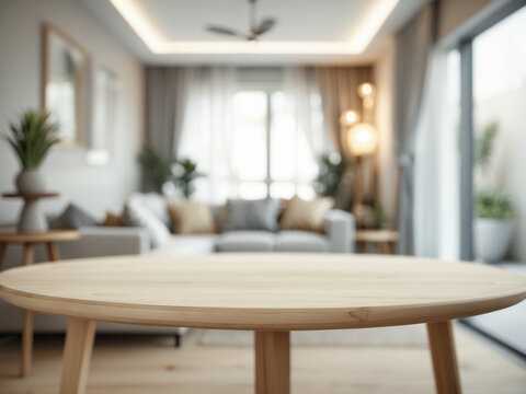 Empty wooden table in the foreground with a blurred modern living room interior. Ideal for product display, mockups, or as a clean backdrop for advertising.