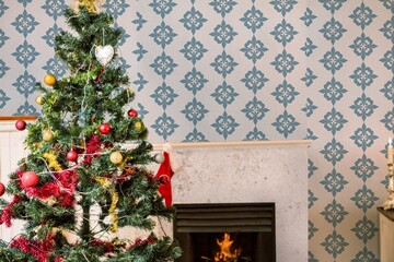 Flat vector showing living room corner is glowing with festive tree with lights and warm fireplace