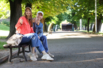 Lovely couple spending time together in park, space for text