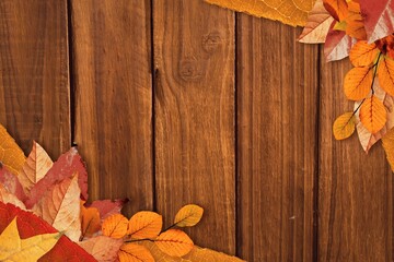 Fototapeta premium Multicolored autumn leaf cluster is resting on flat design wooden plank backdrop