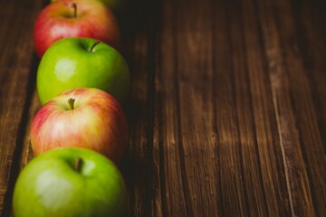 Red and green apples on table
