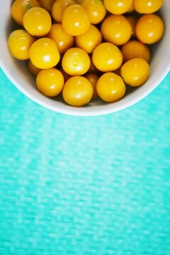 Overhead view of raw cherry tomatoes in bowl