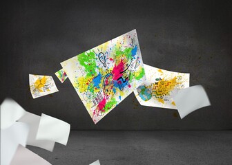 Sheets with graphics and splashes over grey wall