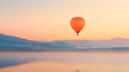 Serene sunrise hot air balloon ride over misty mountains and lake