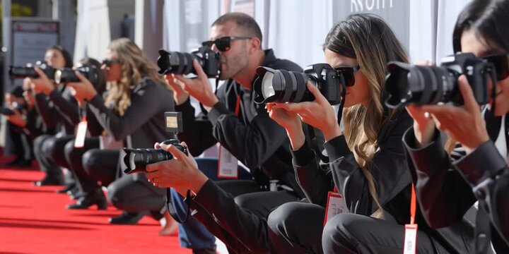 Photographers and media journalists line up on the red carpet to take photos of celebrities